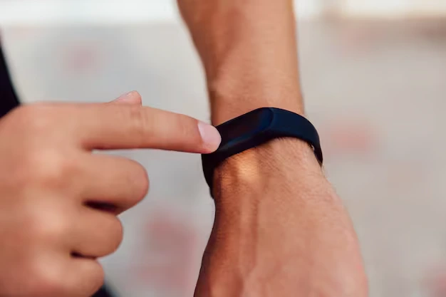 Close-up of a person interacting with a fitness tracker to emphasize the importance of replacing Fitbit watch bands for style and comfort.