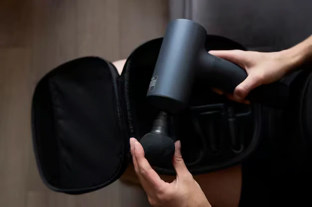 Percussion massage gun used for muscle recovery as one of the top recovery devices.