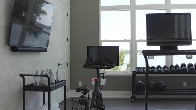 A smart gym setup with digital fitness equipment in a modern home.