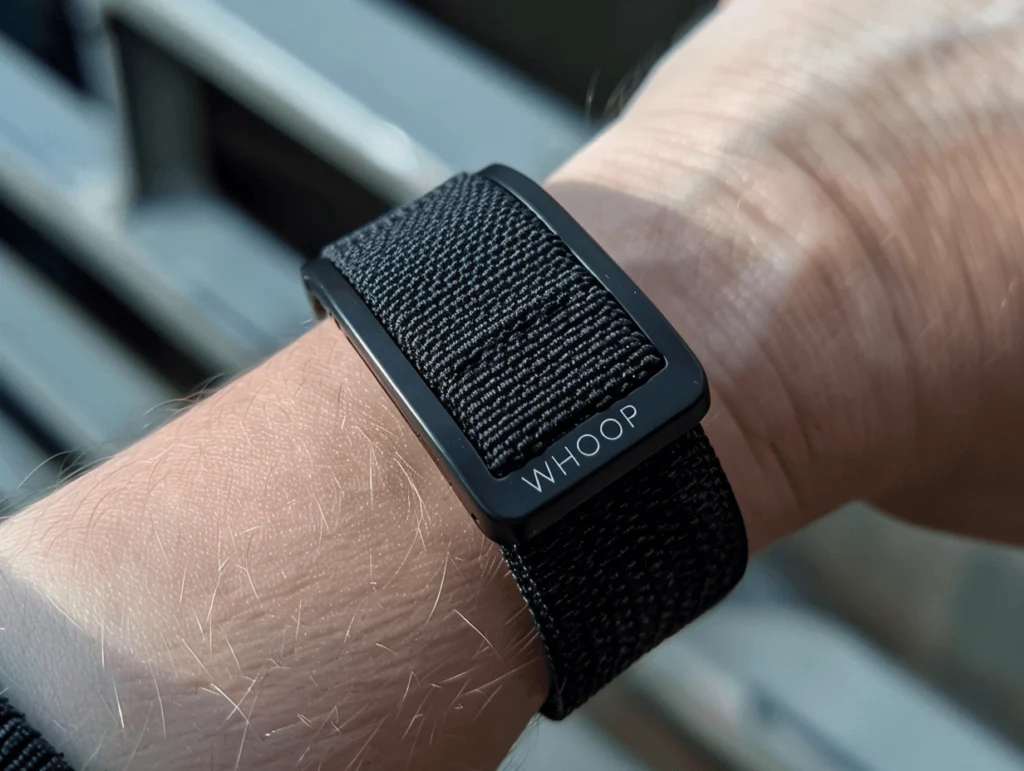 A close-up of a Whoop fitness tracker on a wrist in the Whoop vs Fitbit comparison.
