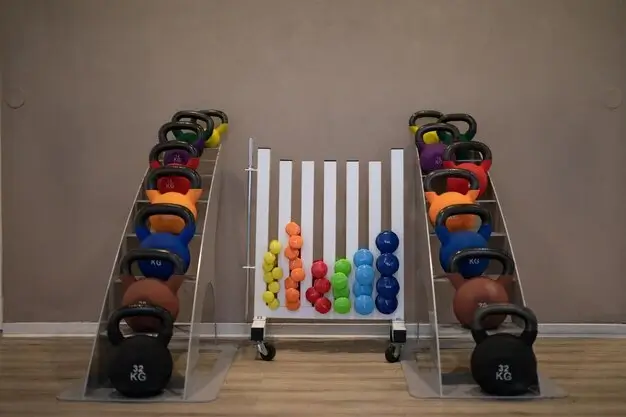 Cost to build a small gym with a well-organized rack of kettlebells and dumbbells for strength training.