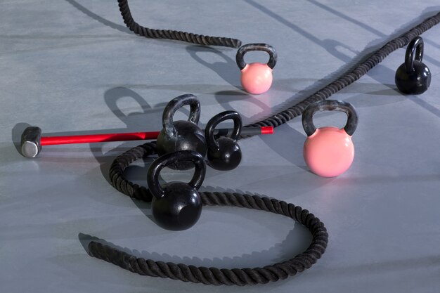 Various fitness equipment like kettlebells, complementing weight stack machine training for a diverse workout.