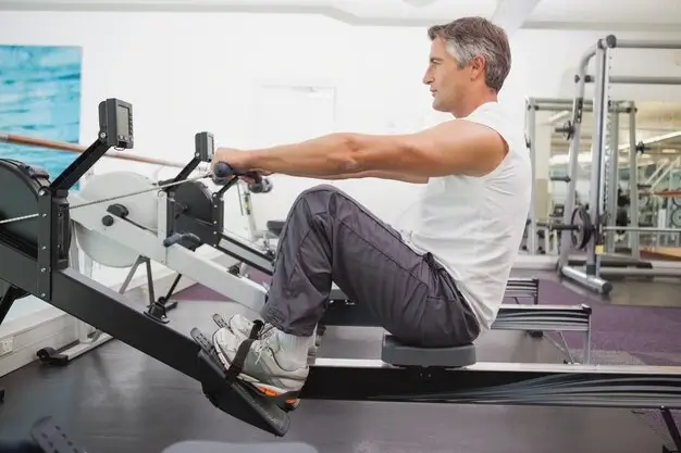 A man using a seated row weight machine for beginners to improve posture and strength.