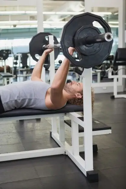 A man using a chest press weight machine for beginners to build upper body strength.